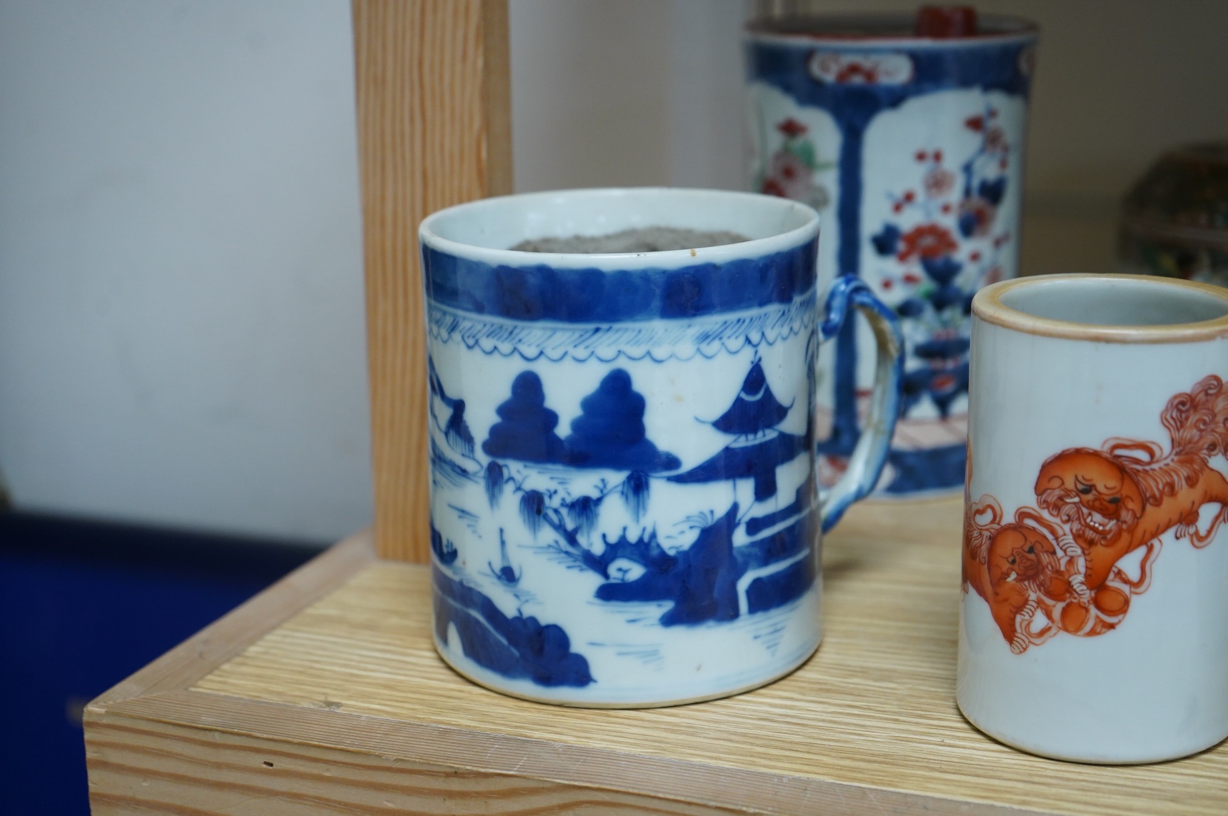 A collection of Chinese ceramics to include a blue and white mug, set of three graduated Canton jars and covers and two cylindrical brush washers